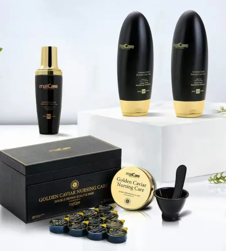 MaxCare Golden Caviar hair care collection displayed on a clean white background. The set includes black and gold bottles of shampoo and conditioner, a serum bottle, a boxed Golden Caviar Nursing Care treatment kit with small pods, a tin container, and a black mixing bowl with a spatula, designed for double repair of scalp and hair.